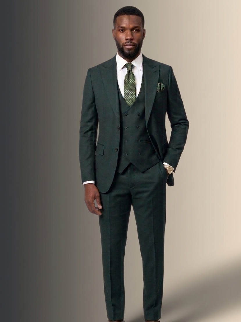 Man wearing a dark green suit with a white shirt and patterned tie on a gradient background